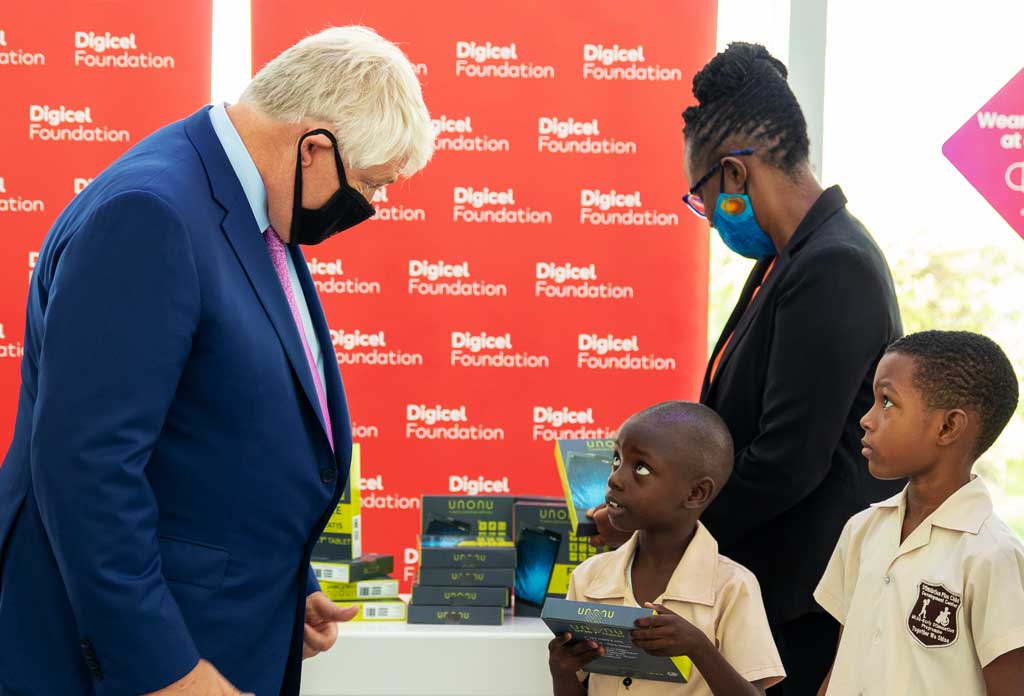 Founder and chairman of Digicel Denis O'Brien gives tablets to special needs children on behalf of the Digicel Foundation