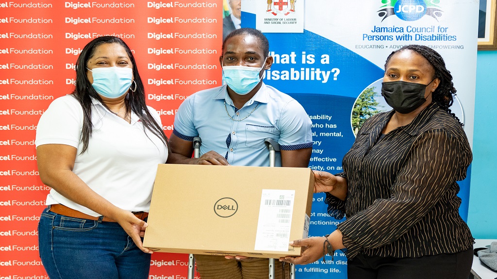 Digicel Jamaica Foundation CEO presents laptop to Jamaican student with special