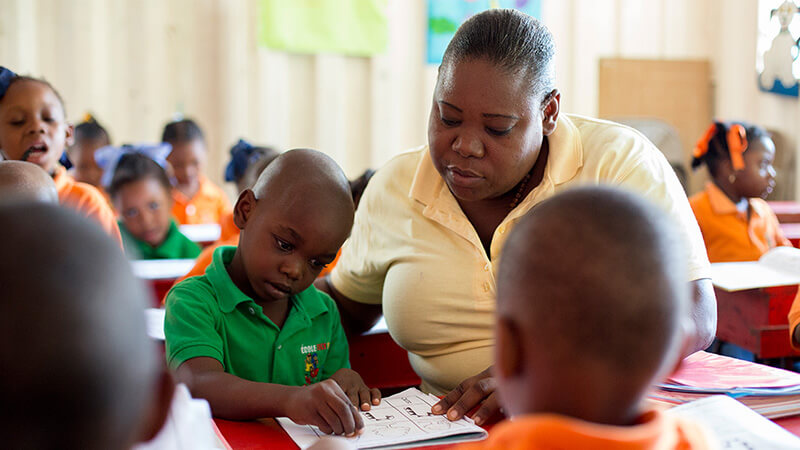 A teacher assists students in the classroom