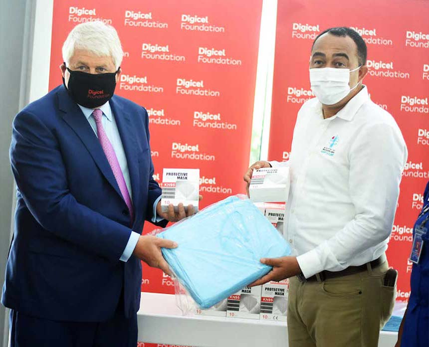 Denis O’Brien presents Dr Christopher Tufton of Kingston Public Hospital with personal protective equipment.